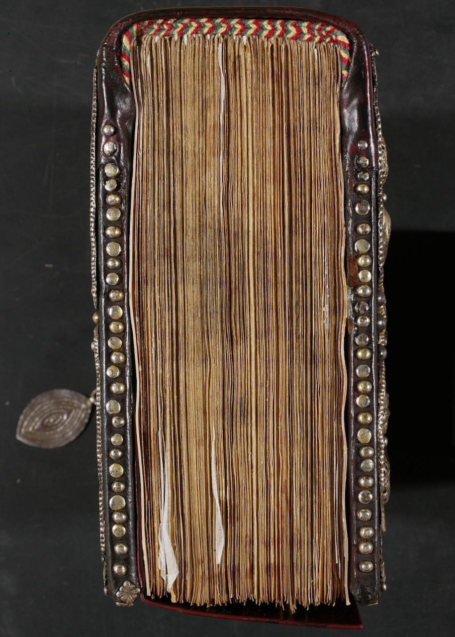 overhead view of textblock, sewn binding, and protective leather cover