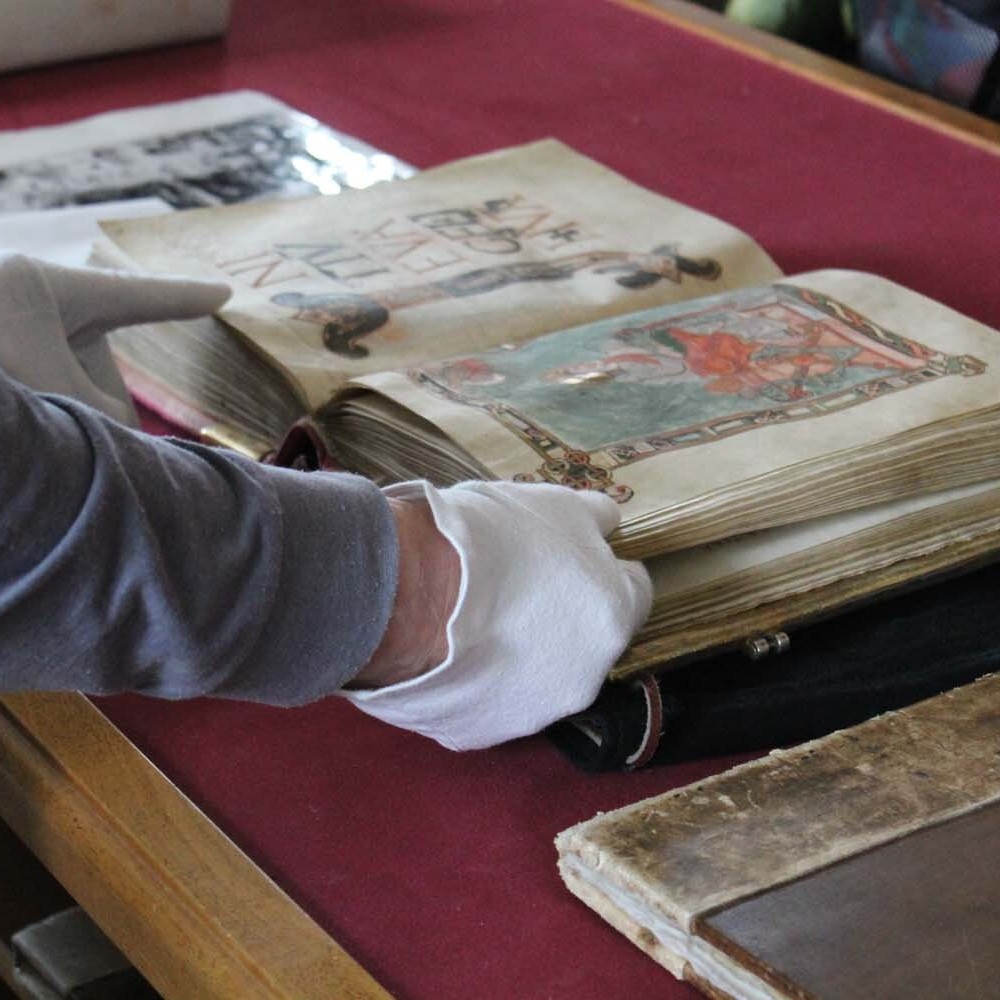 Hauke Fill, long-time librarian at Kremsmuenster, presents a manuscript from the collection (2015 photograph by Dr. Matt Heintzelman)